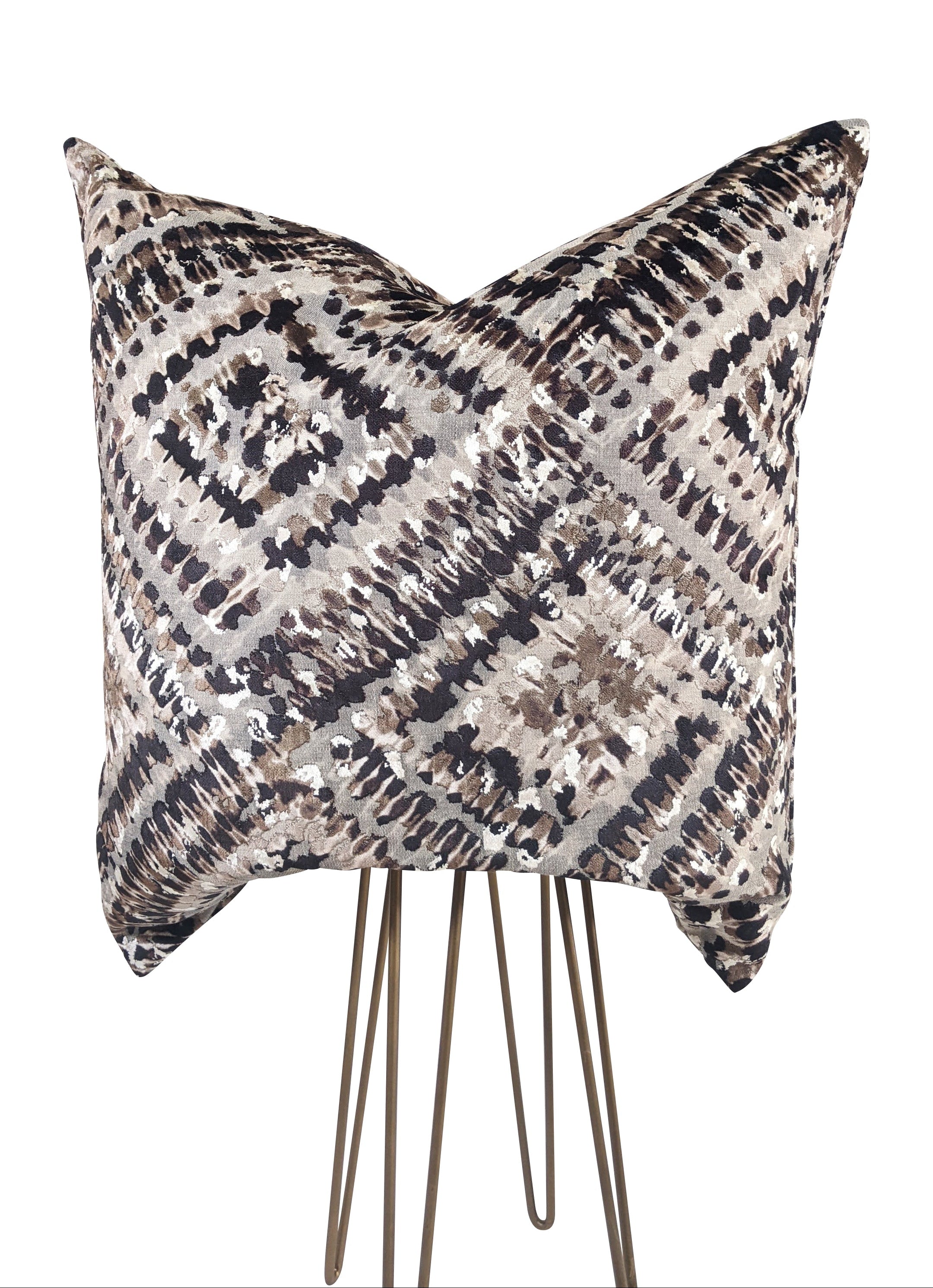 A cut velvet animal print pillow featuring a bold pattern with black, silver, and cream colors, displayed on a simple background.