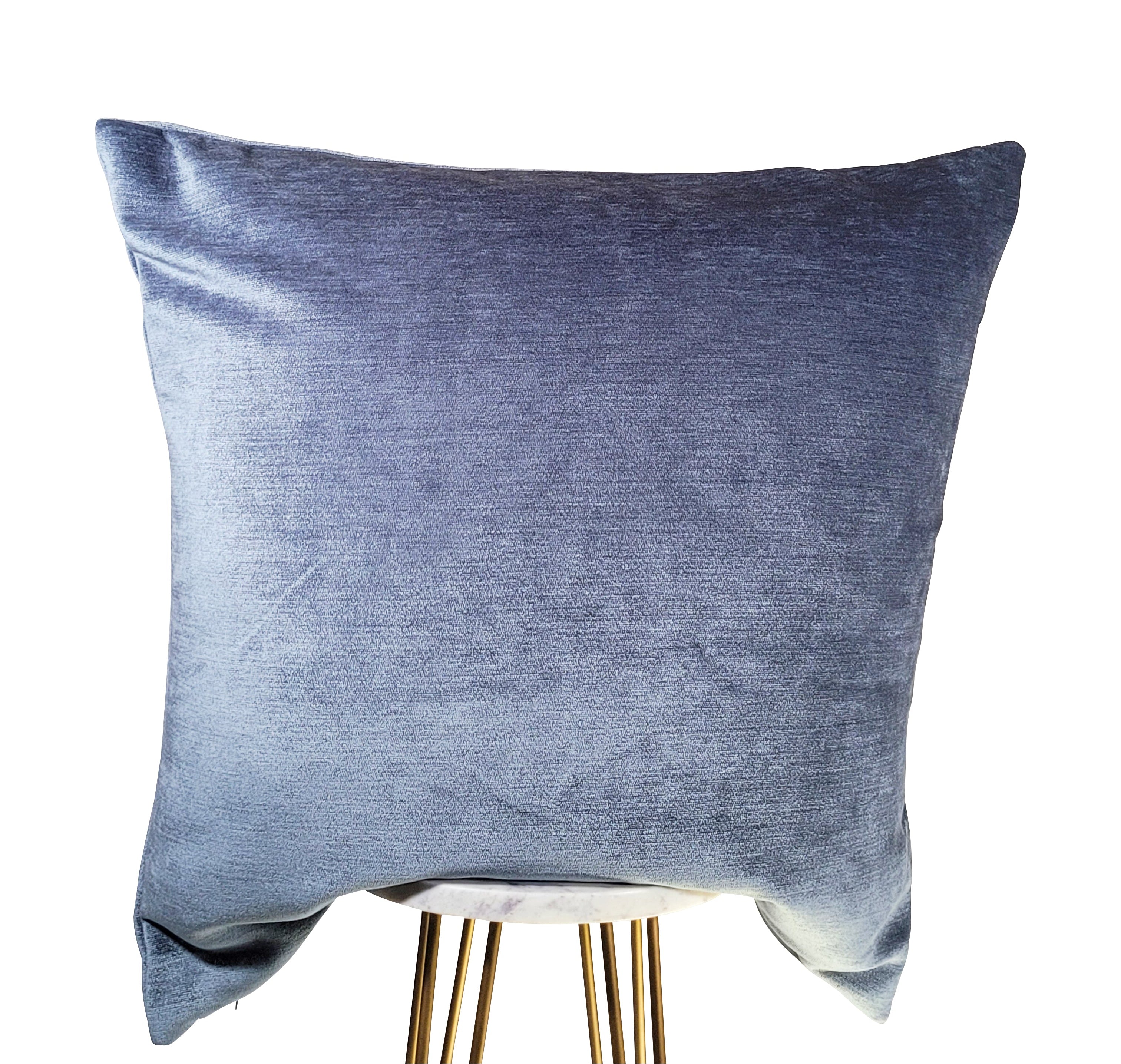 A square-shaped baby blue velvet throw pillow with a hidden zipper closure.
