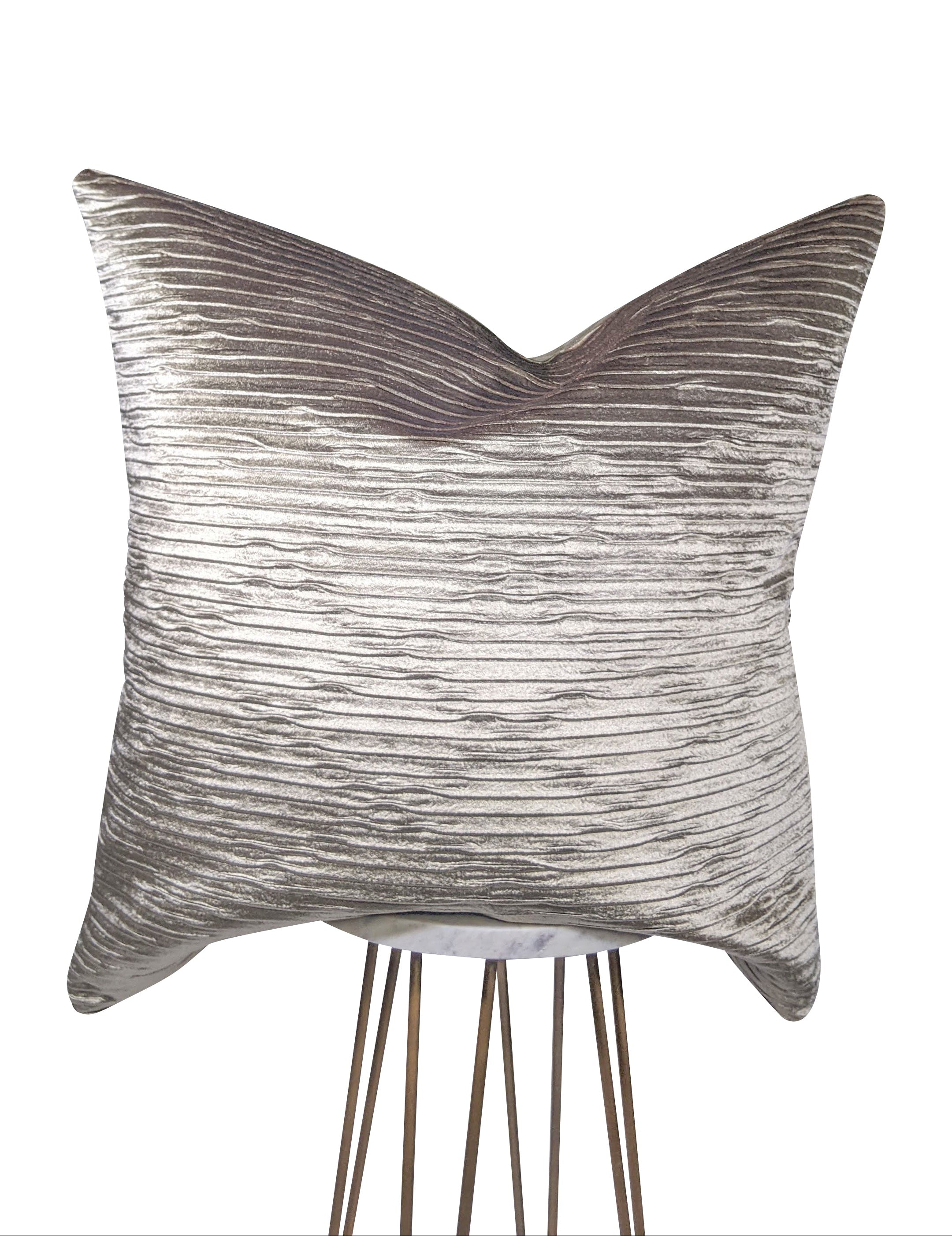 Textured pillow on a stand against a white background