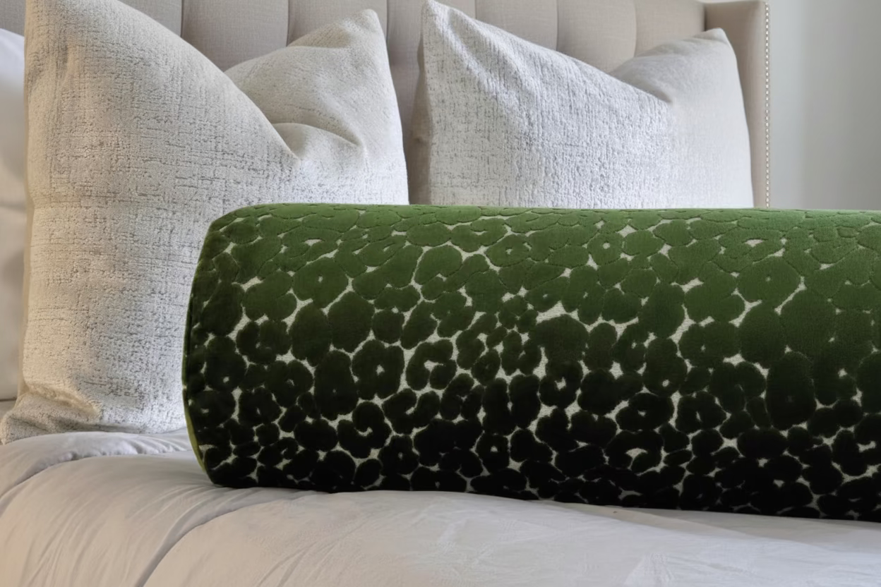Green patterned pillow on a textured surface