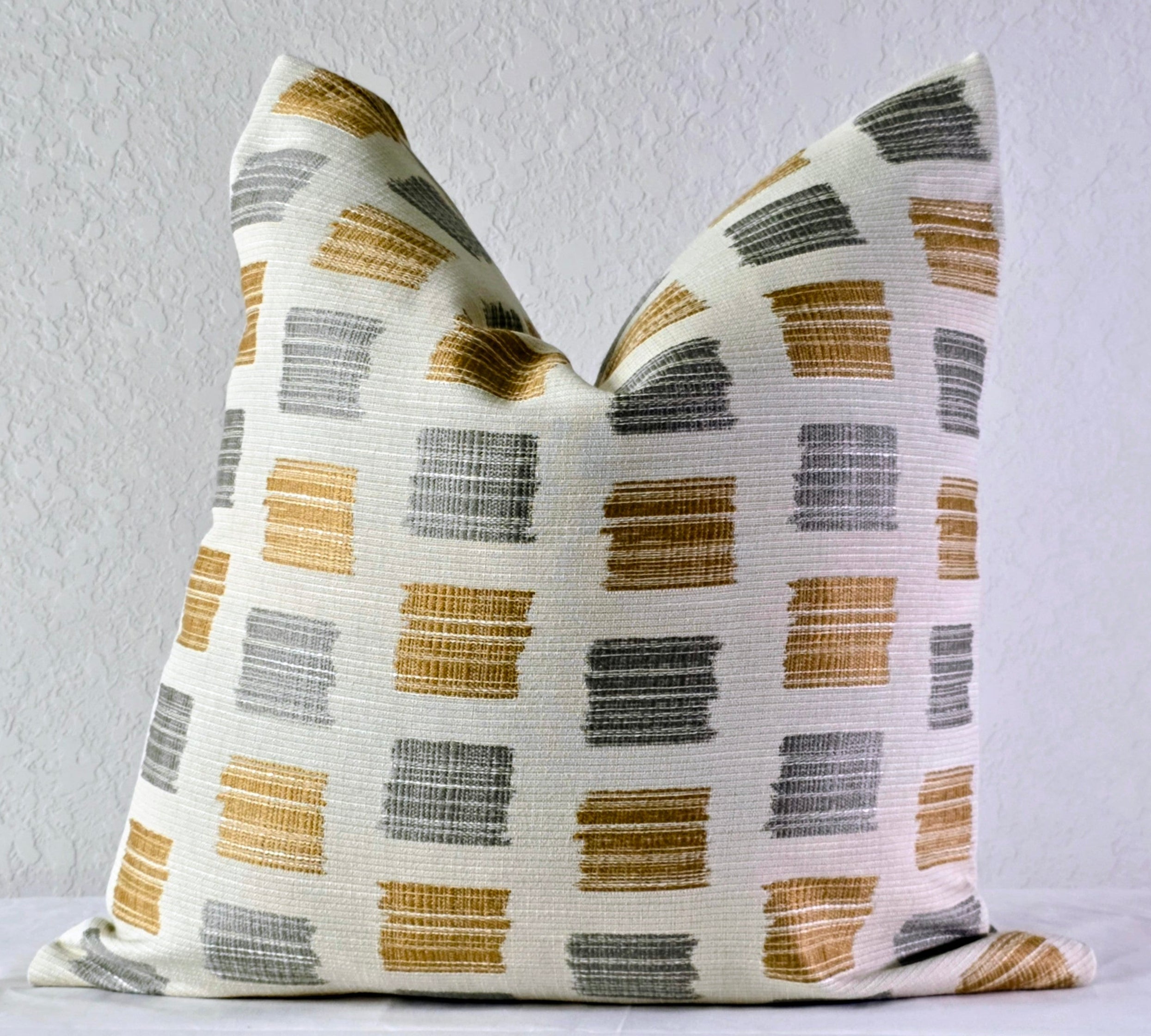 Decorative pillow with geometric pattern on a white surface