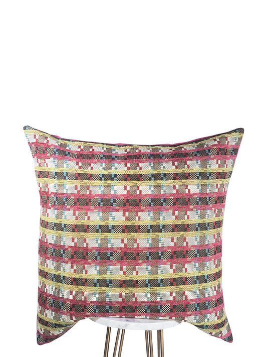 A square-shaped pink pillow with a geometric pattern featuring stripes in fuchsia, green, white, and blue colors.