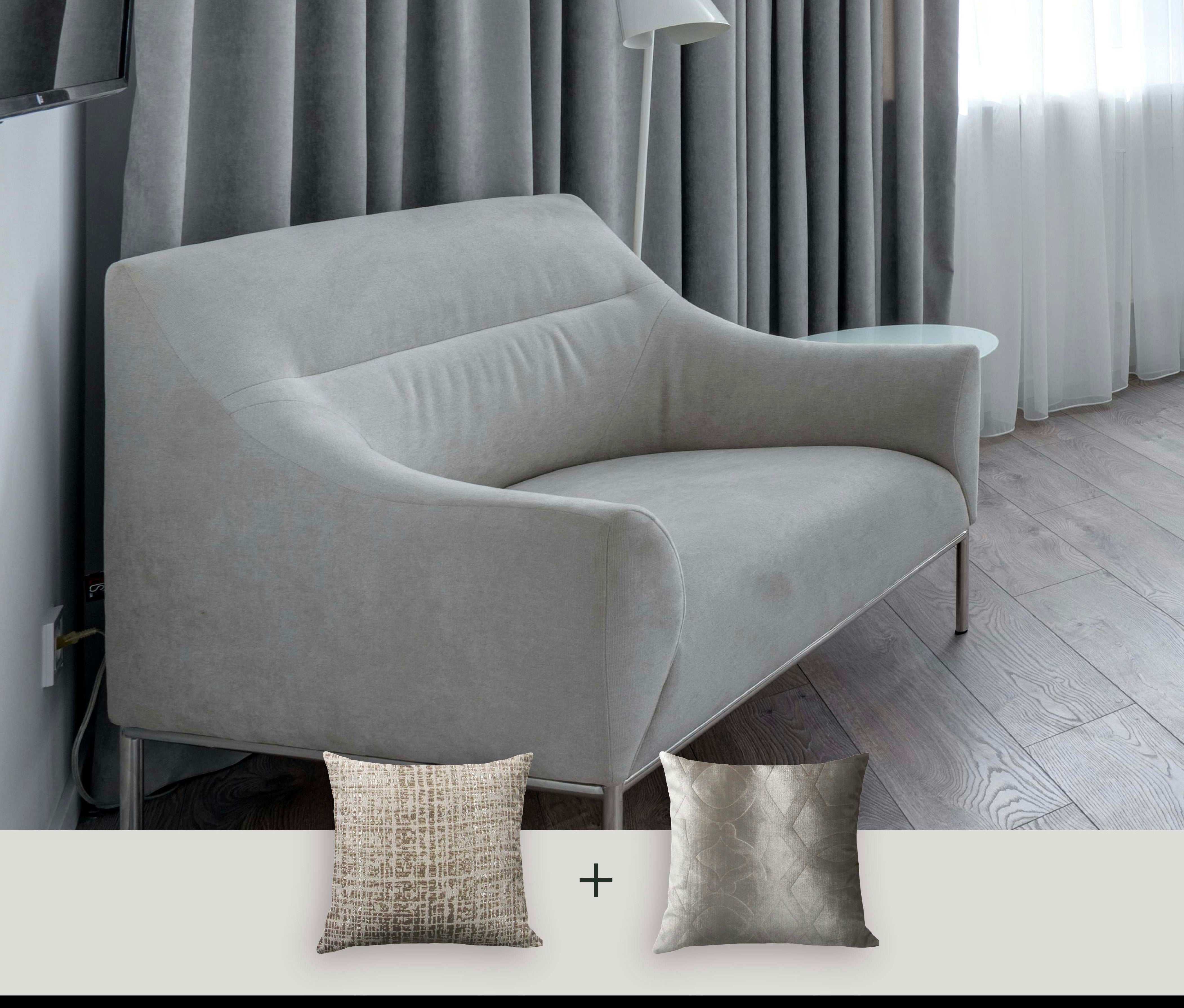 Gray sofa with decorative pillows in a room setting, featuring the brand 'Makena Decor'.