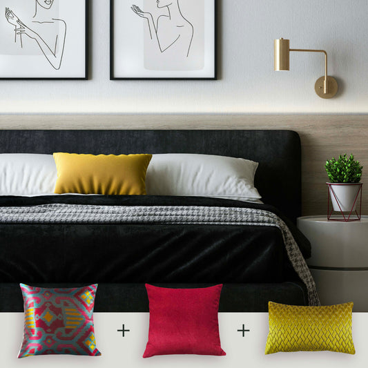 Modern bedroom with a bed featuring colorful pillows and wall art.