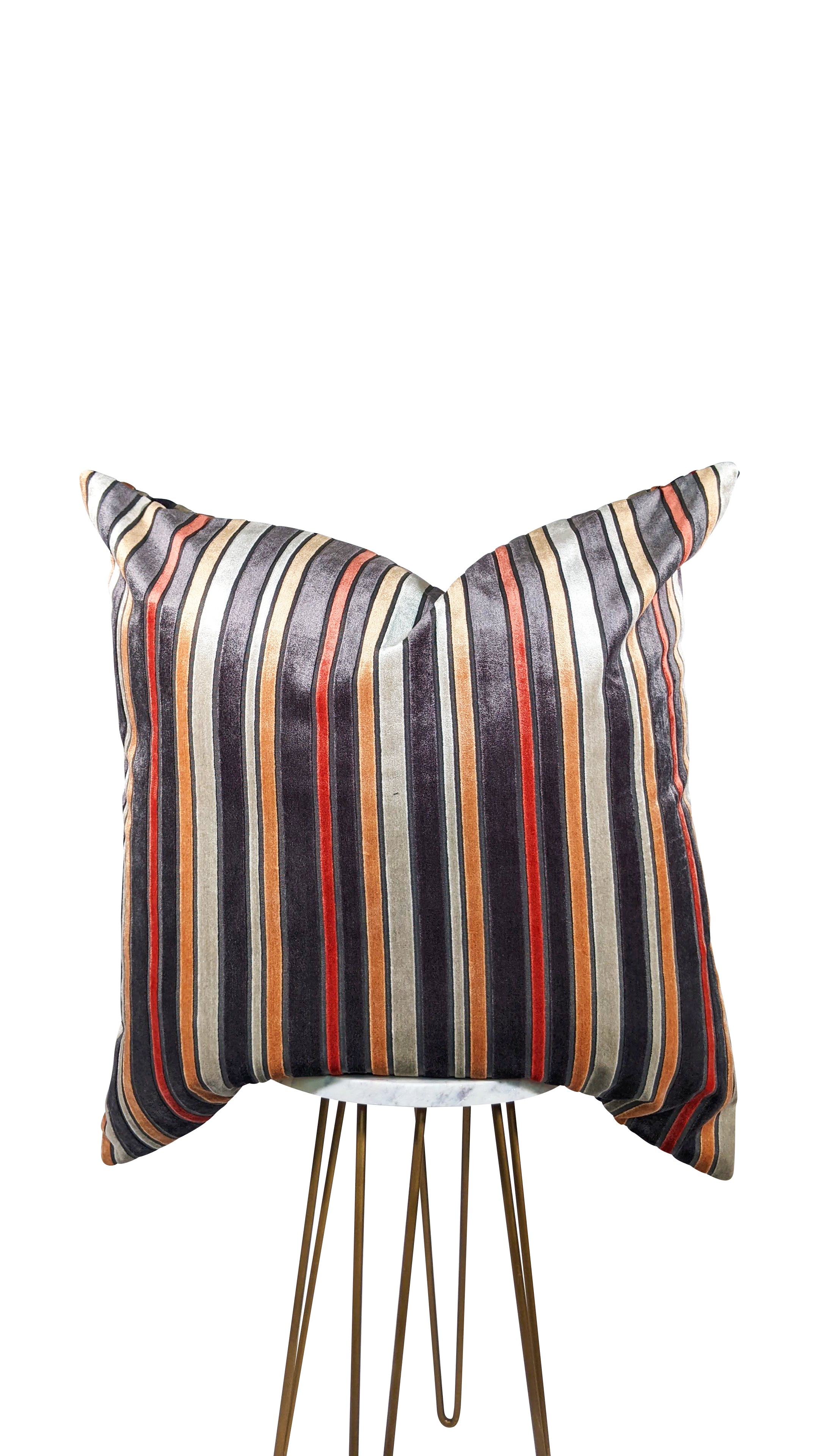 A square-shaped throw pillow with a pattern of burnt orange and gray stripes on a gray background, showcasing a hidden zipper closure.
