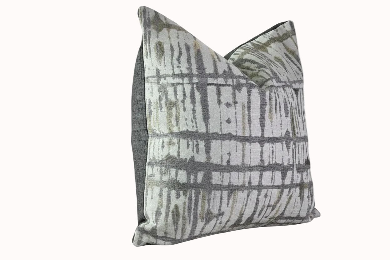 Decorative pillow with gray and white pattern on a white background