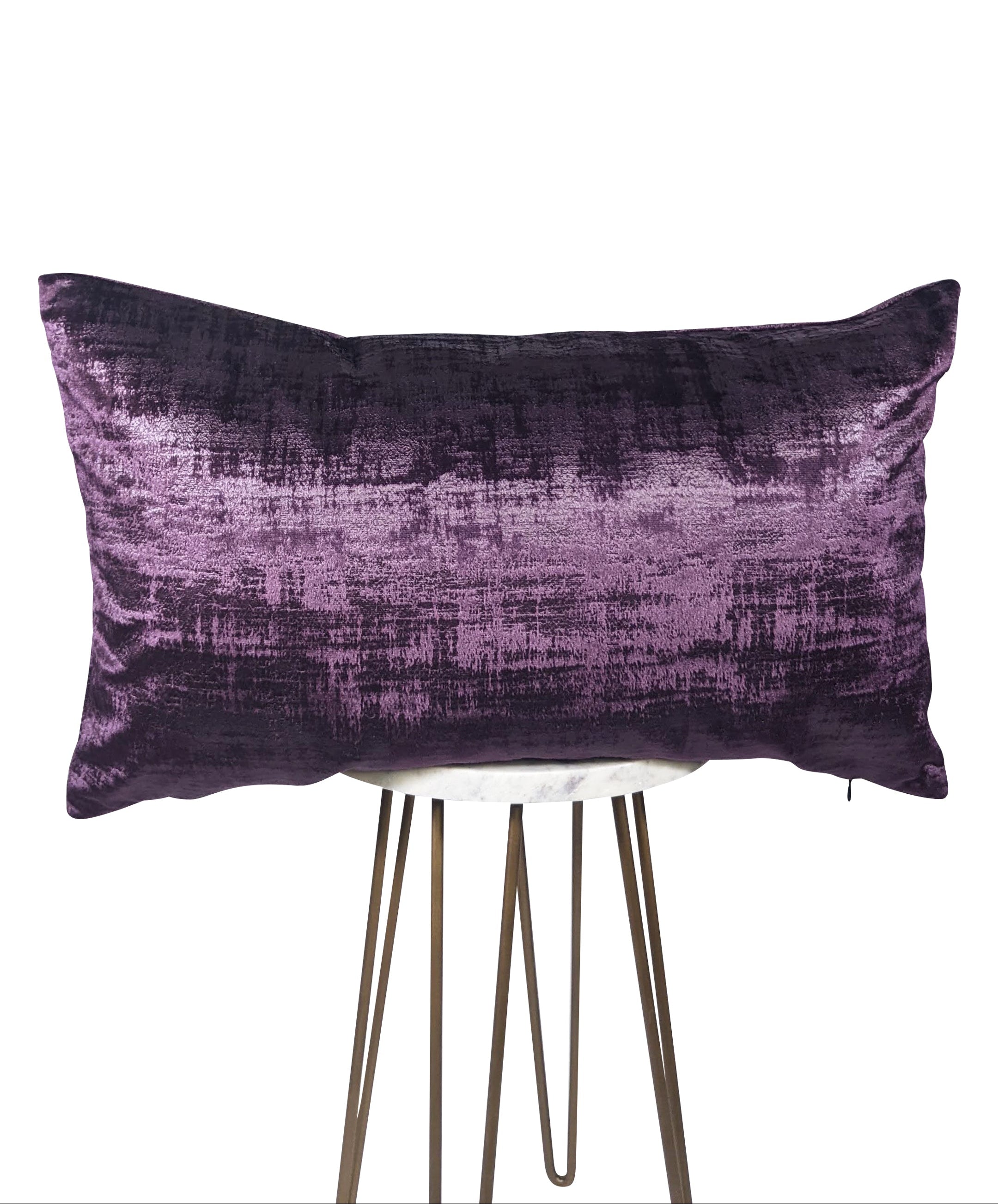 Purple textured pillow on a stand against a white background