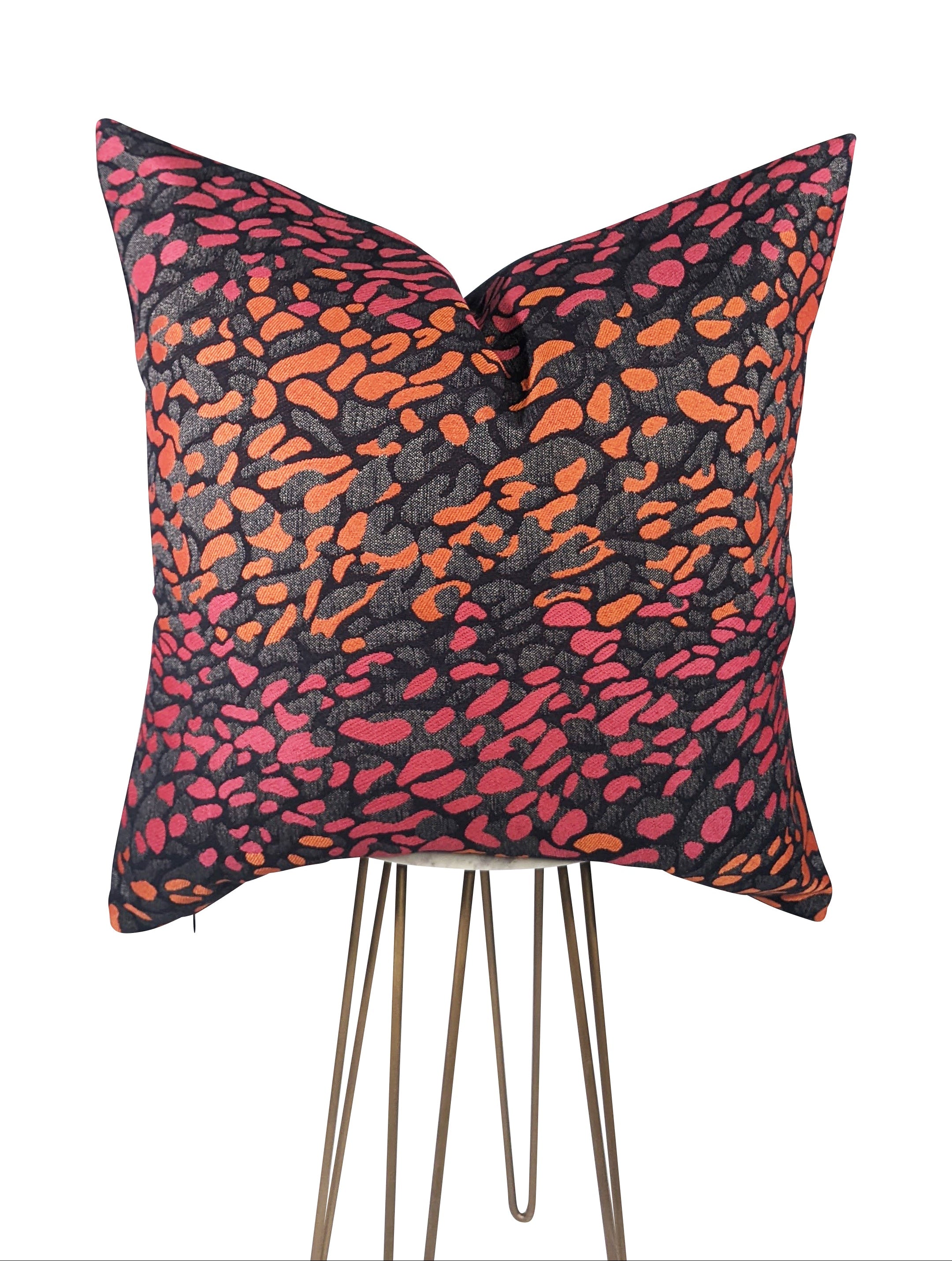 Decorative pillow with a colorful abstract pattern on a white background