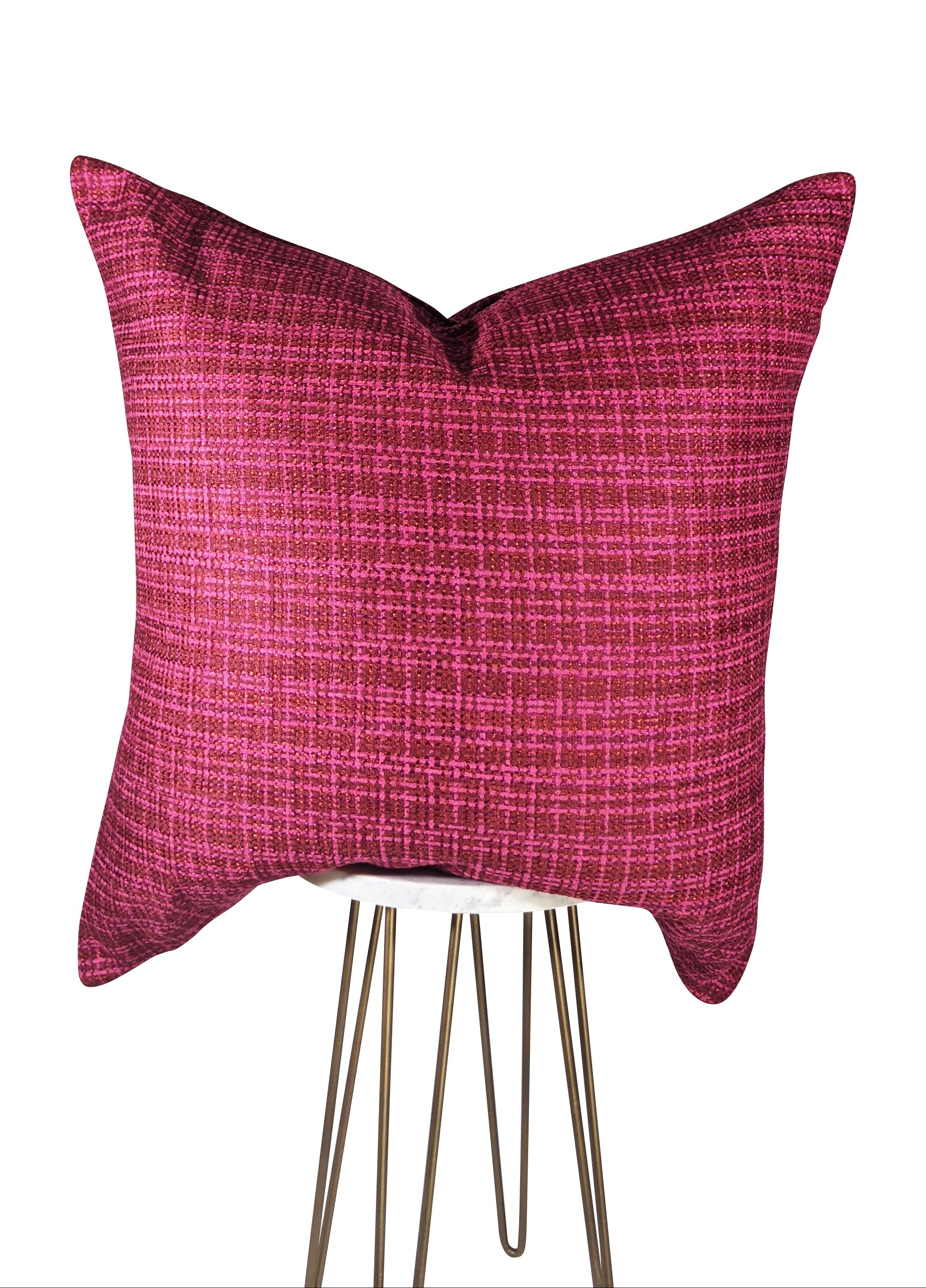 A rectangular throw pillow with a raspberry red color and hot pink plaid pattern