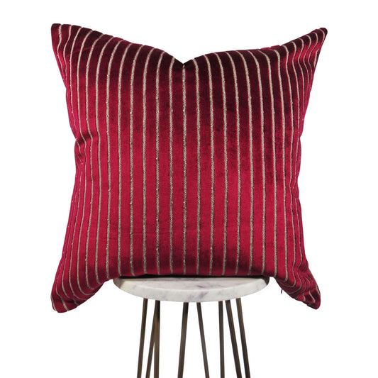shiny fuchsia 20x20 square throw pillow with indented lines throughout, displayed on small white table.