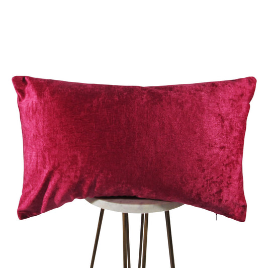 Shiny velvet hot pink 13x21 rectangle throw pillow, displayed on a small white table.