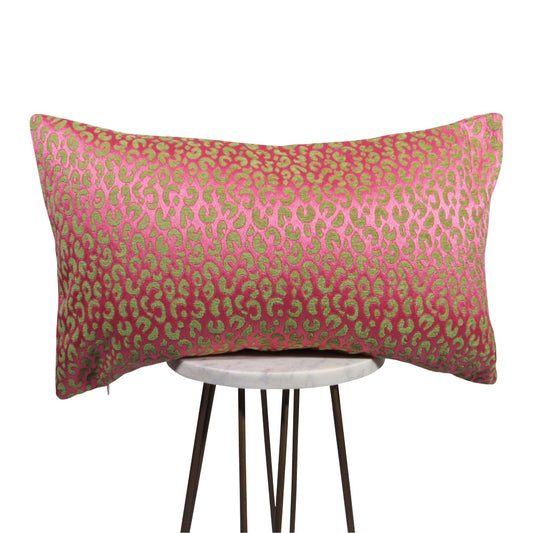 shiny pink and green animal print lumbar pillow on small white table.