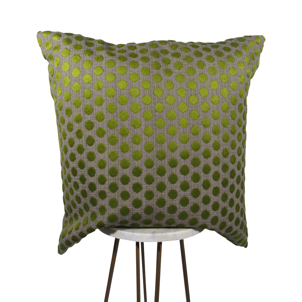 small velvet green dots on a gray backdrop 20x20 square throw pillow, displayed on small white table.