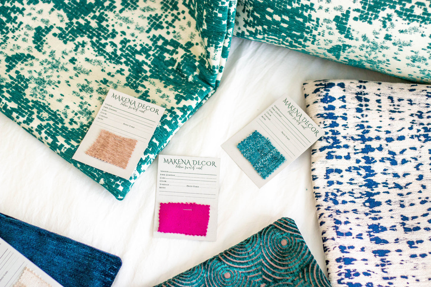 Makena Decor fabric swatches and green, white and blue pillow covers on white background