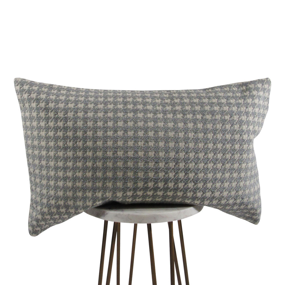 off white and light gray 13x21 rectangle throw pillow with houndstooth design, displayed on a small white table.