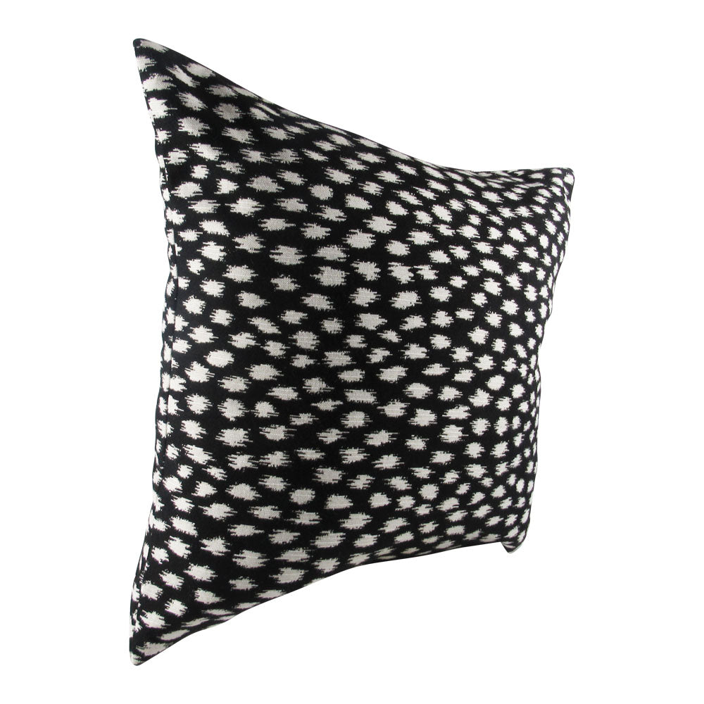 black over white spot pattern on a decorative throw pillow cover.