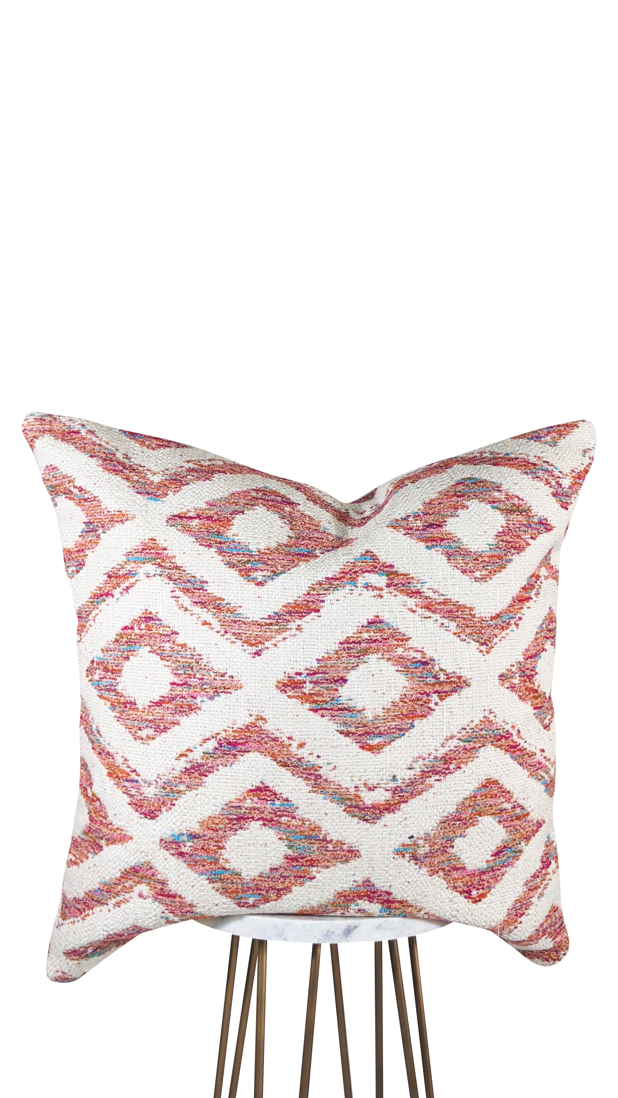 A square-shaped pillow with a geometric diamond pattern featuring fuchsia, pink, blue, and orange colors on an ivory background.