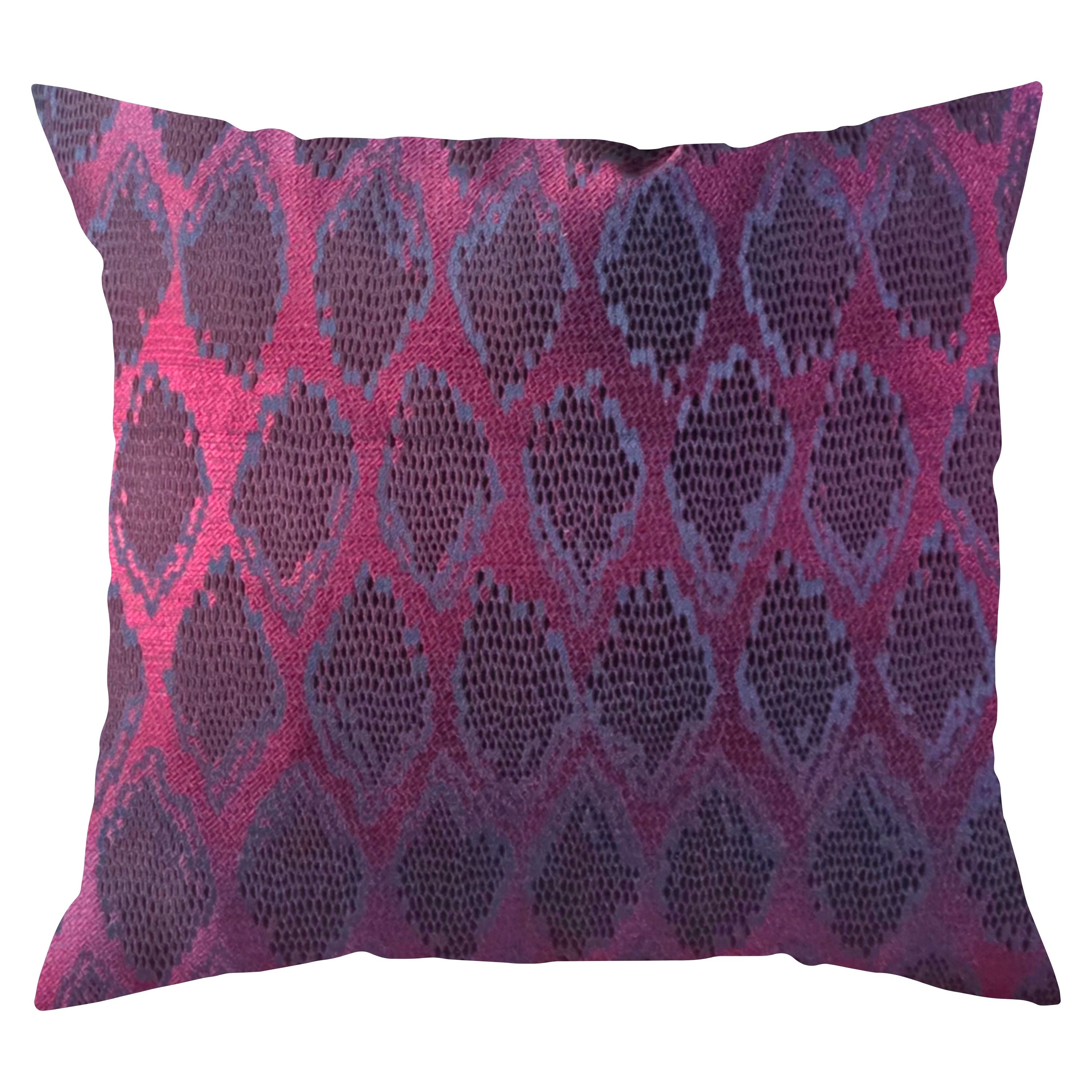 Decorative pillow with a burgundy and navy blue geometric pattern on a white background