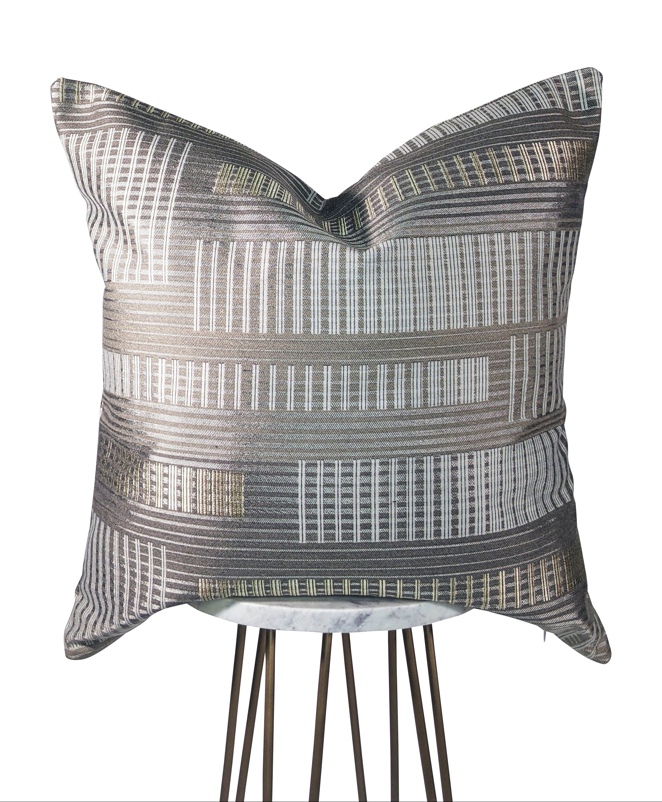A square metallic striped pillow with geometric patterns in gold, tan, and white colors, featuring a hidden zipper closure.