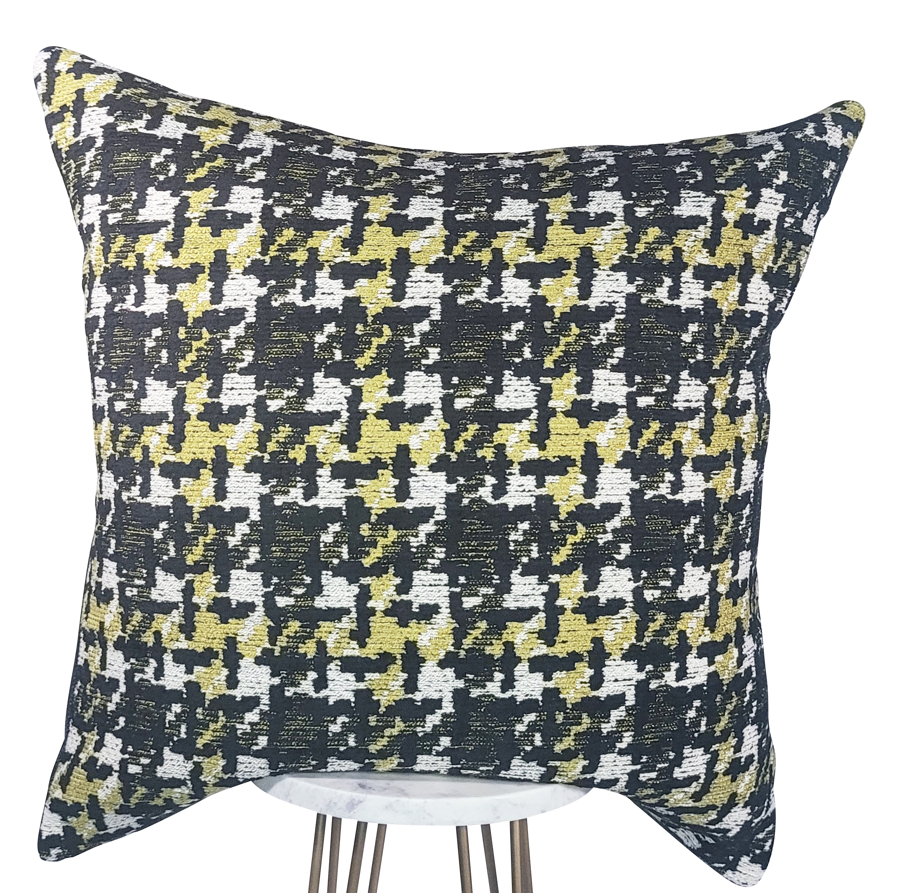 A rectangular pillow with a black, white, and lime green houndstooth pattern, displayed on a white stand.