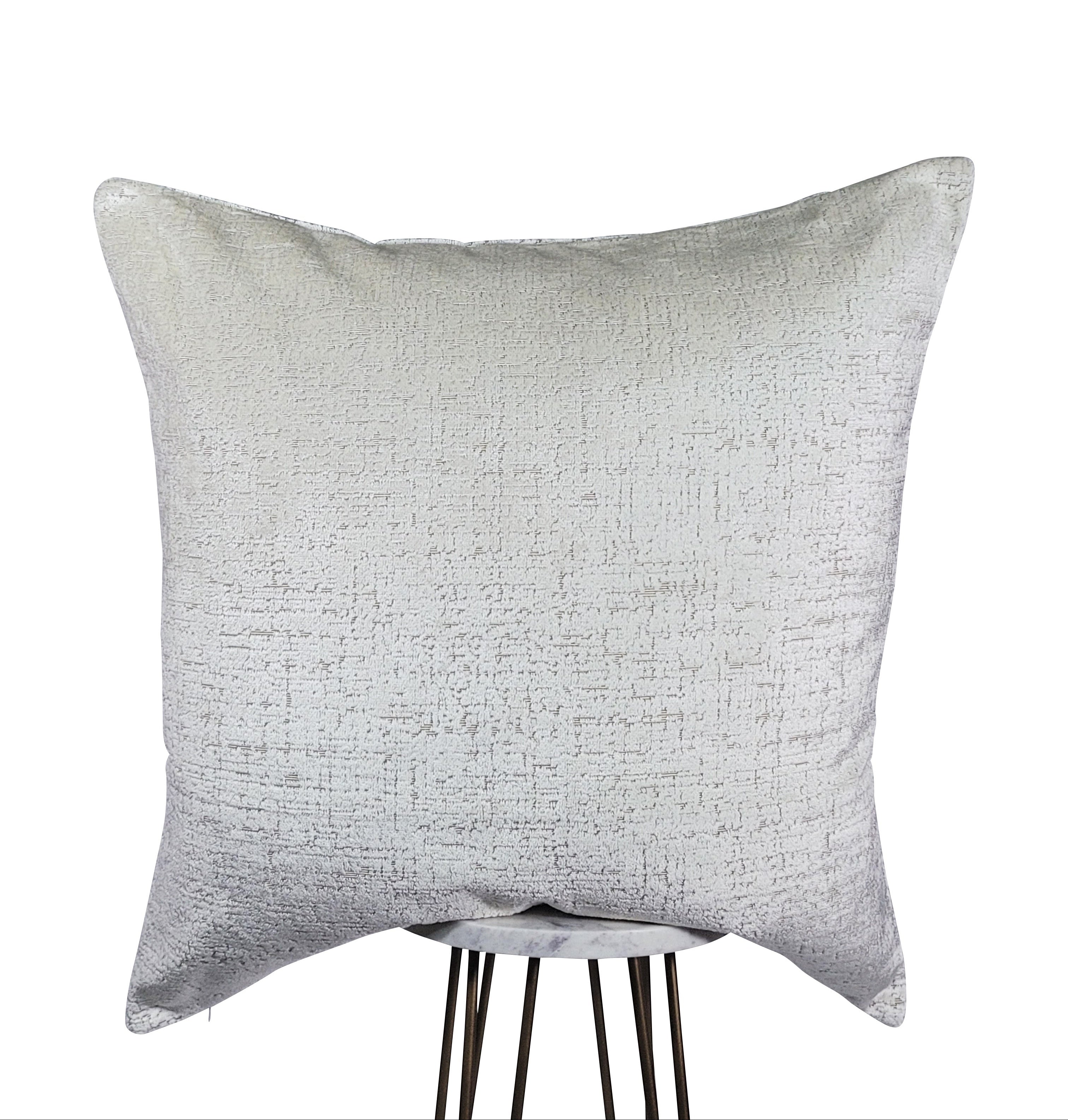 A square-shaped white throw pillow with an indented design, presented against a white background.
