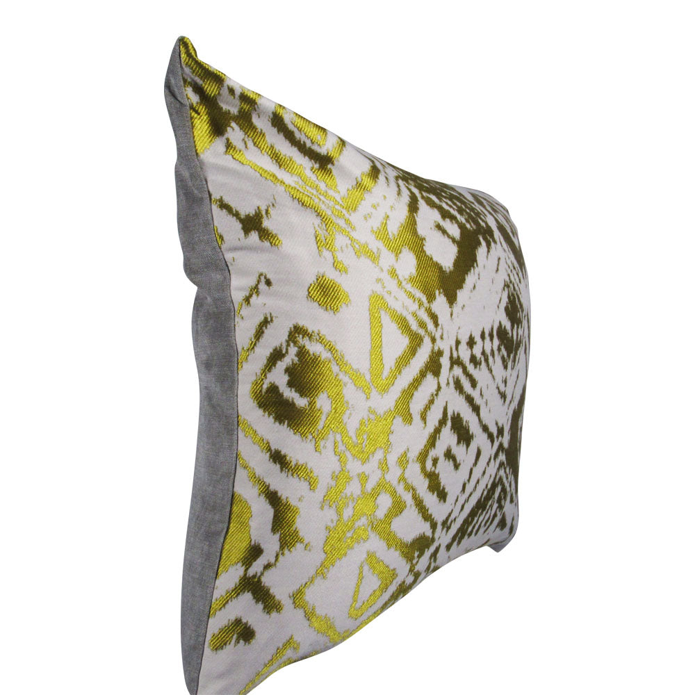 side-view of shiny gold square throw pillow with designs 