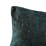 up-close view of a velvet forest green throw pillow with circle designs throughout.