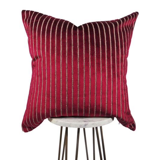 shiny fuchsia 20x20 square throw pillow with indented lines throughout, displayed on small white table. 