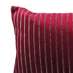 up-close view of a shiny fuchsia throw pillow with indented lines throughout.