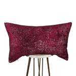 fuchsia and cream 13x21 rectangle throw pillow with rippled design throughout, displayed on small white table