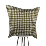 yellow, cream and olive green 20x20 square throw pillow with houndstooth design throughout, displayed on small white table.