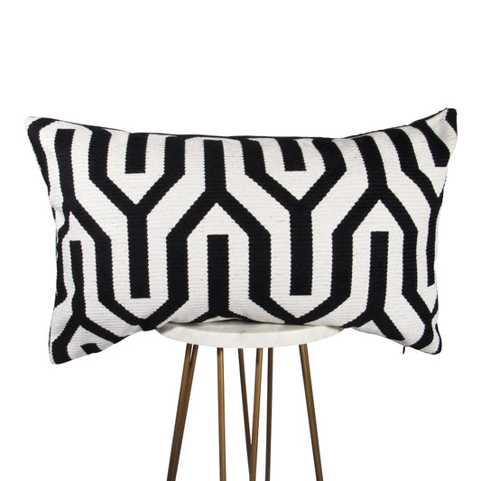 black and white 13x21 rectangle throw pillow with large geometric design throughout, displayed on small white table.