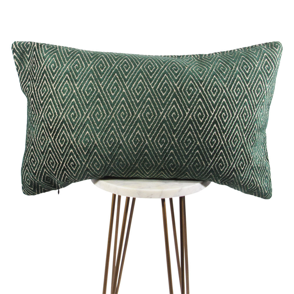 forest green and cream 13x21 rectangle lumbar throw pillow with geometric shapes, displayed on a small white table.