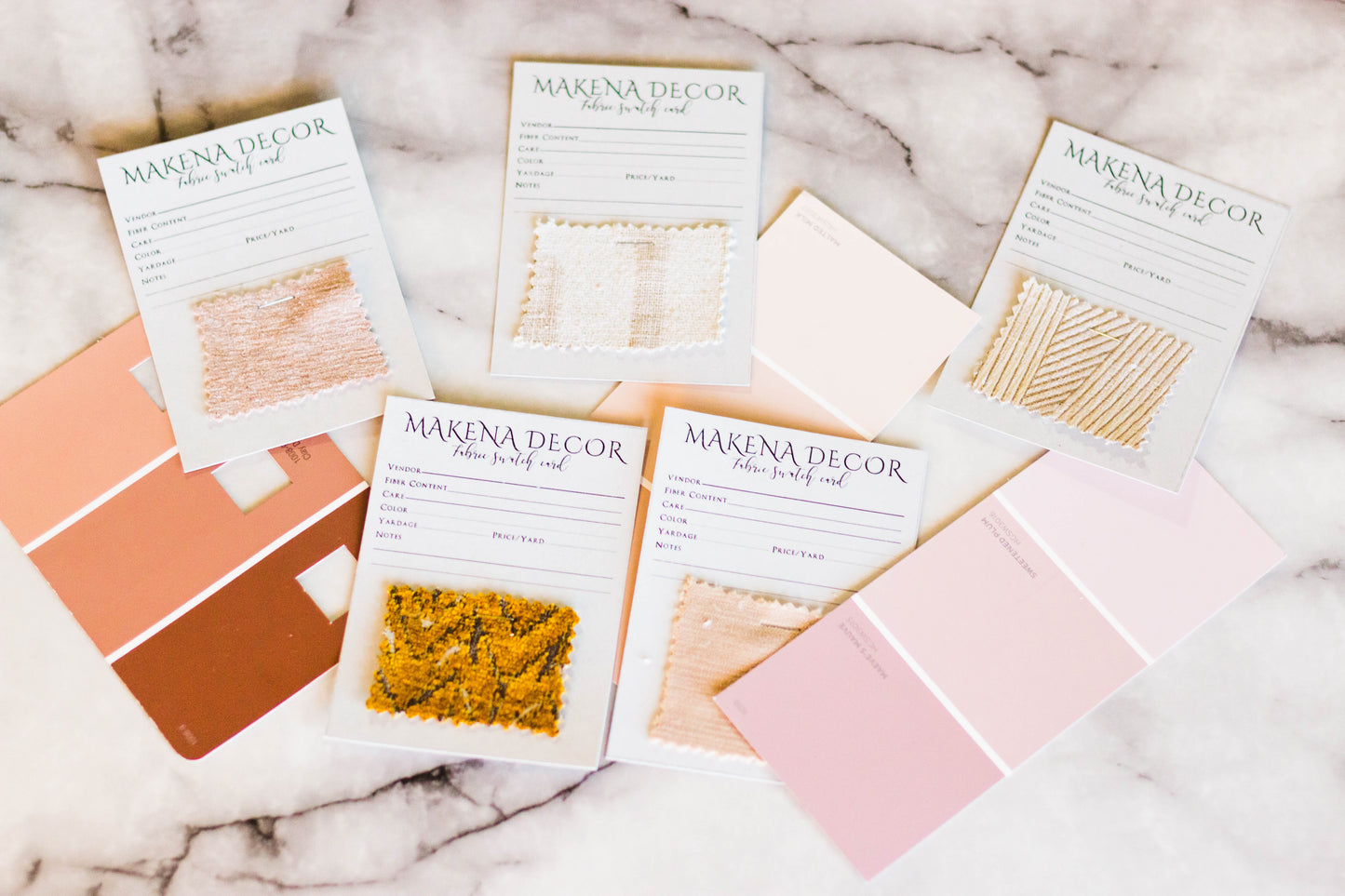 Makena Decor fabric swatches on white marbled table