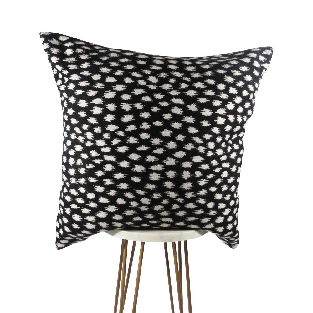 Black and white spotted throw pillow cover, product shot by Makena Decor.